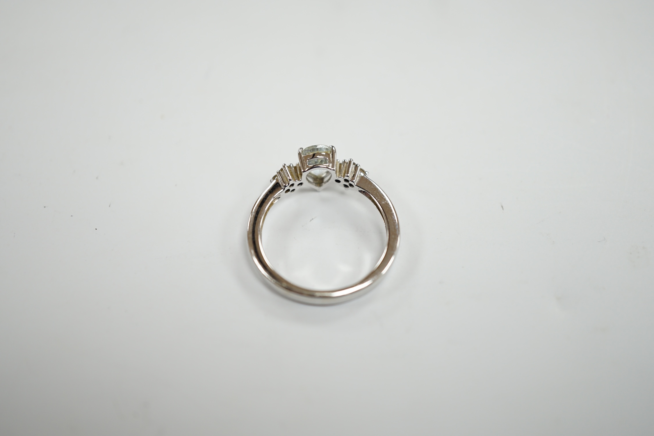 A modern Italian Comete 18k white metal and single stone pear cut aquamarine set ring, with eight stone diamond cluster set shoulders, size N, gross weight 3.3 grams.